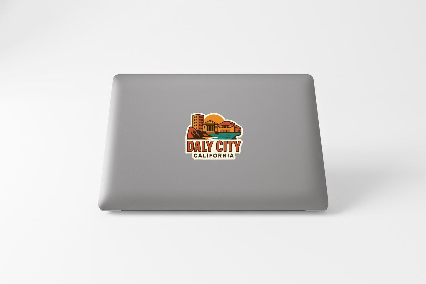 a sticker on the back of a laptop that says "Daly City, California".