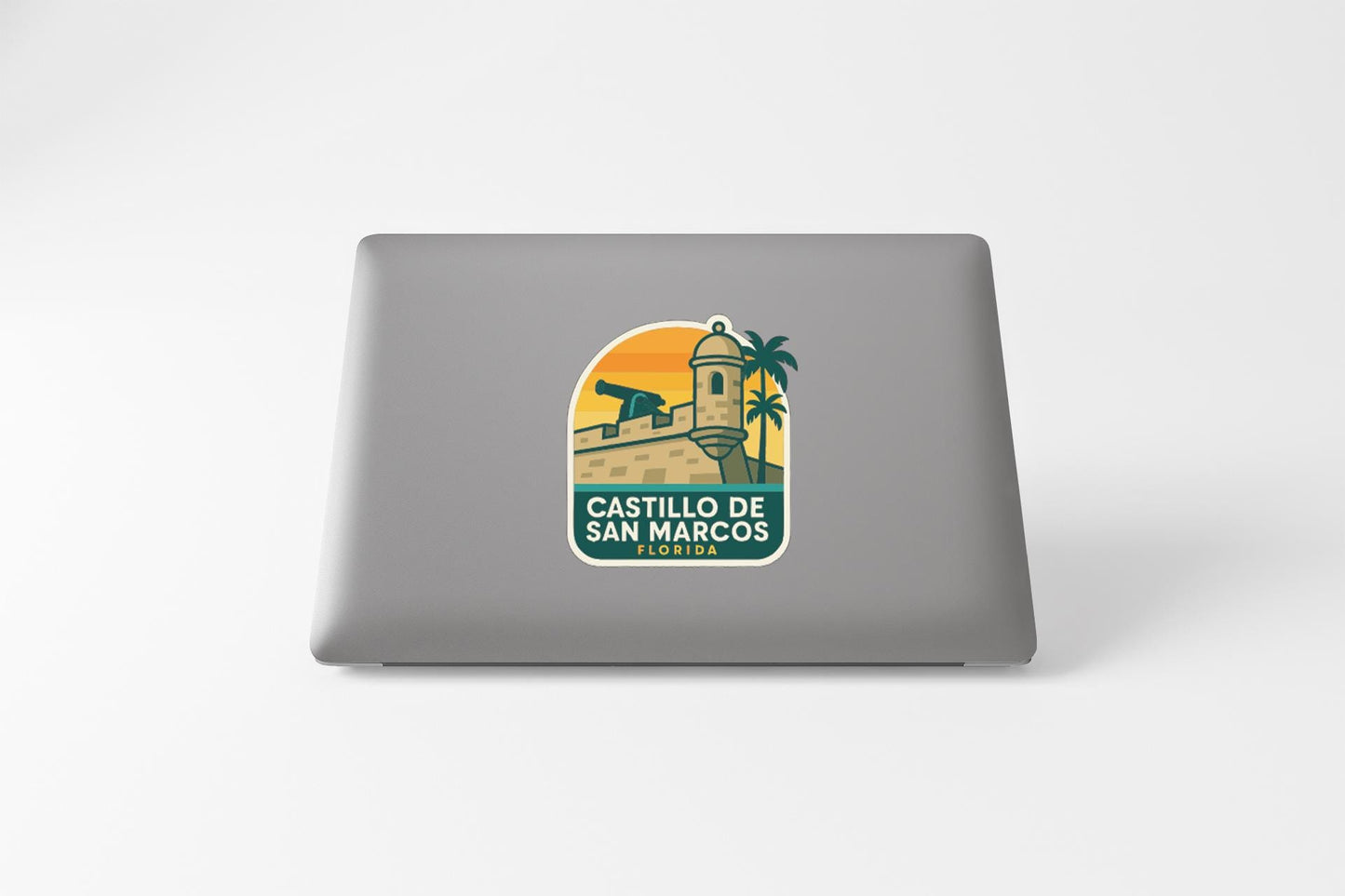 a sticker with a graphic of a building and palm trees, along with the text "CASTILLO DE SAN MARCOS" and "CASTELLO DE SAN MARCOS".