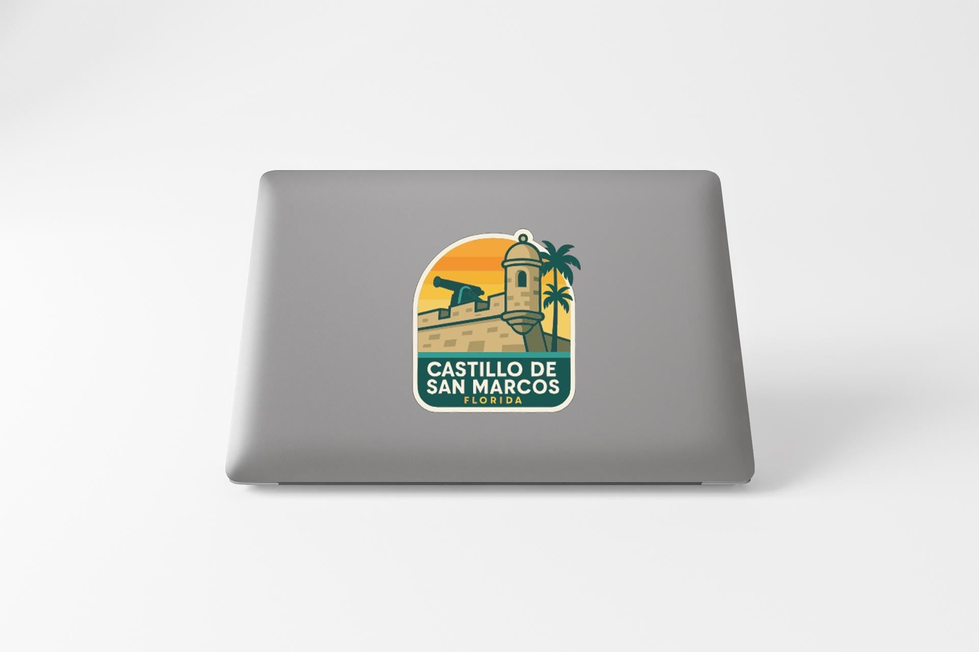 a sticker with a graphic of a building and palm trees, along with the text "CASTILLO DE SAN MARCOS" and "CASTELLO DE SAN MARCOS".