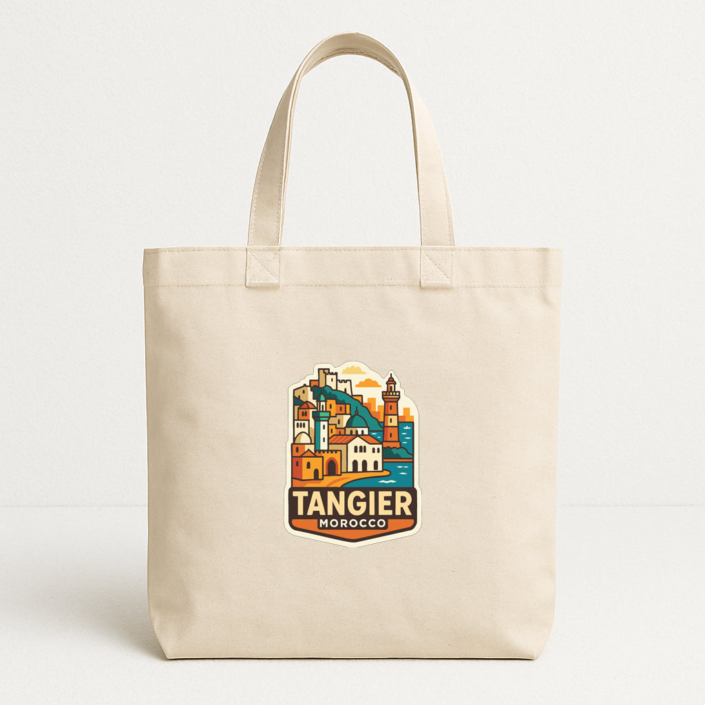 A beige tote bag with a printed design of a cityscape and the text "TANGIER MOROCCO" printed on it.
