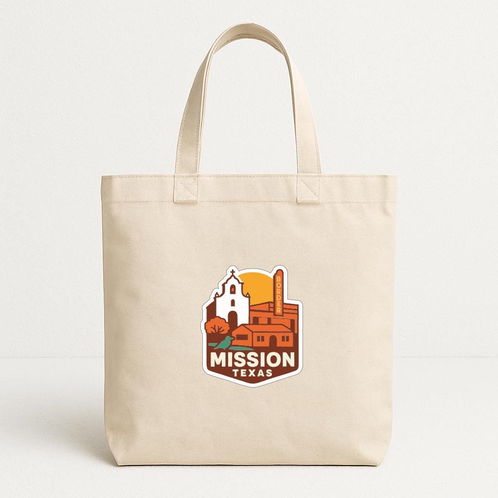 A beige tote bag with a graphic design featuring a church and a sunset, along with the text "MISSION TEXAS".