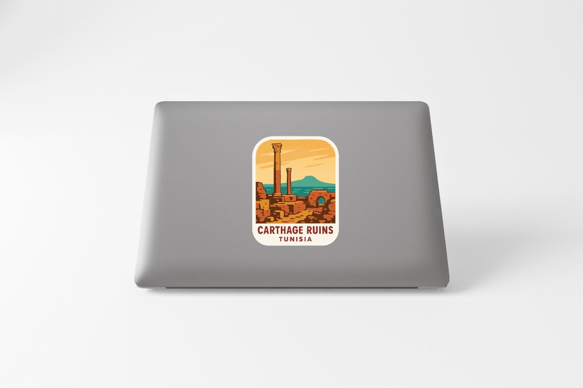 A sticker on the back of a laptop, depicting the Carthage ruins in Tunisia.