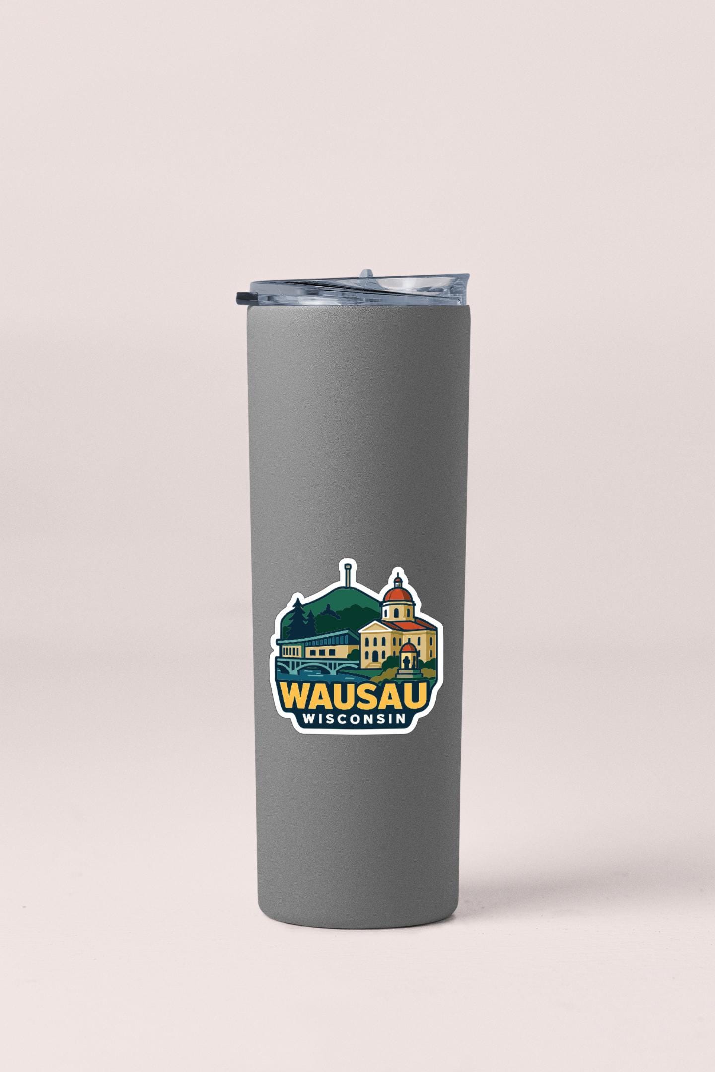 A gray insulated tumbler with a sticker depicting a scenic view of Wausau, Wisconsin.