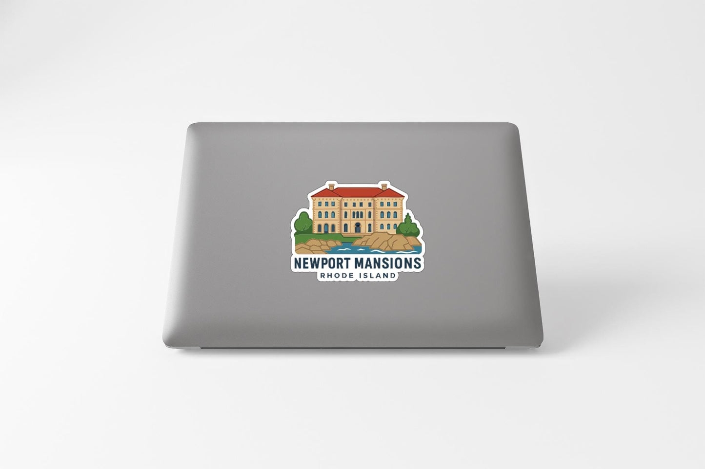 A sticker on the back of a laptop, depicting a building with a red roof and surrounded by trees.