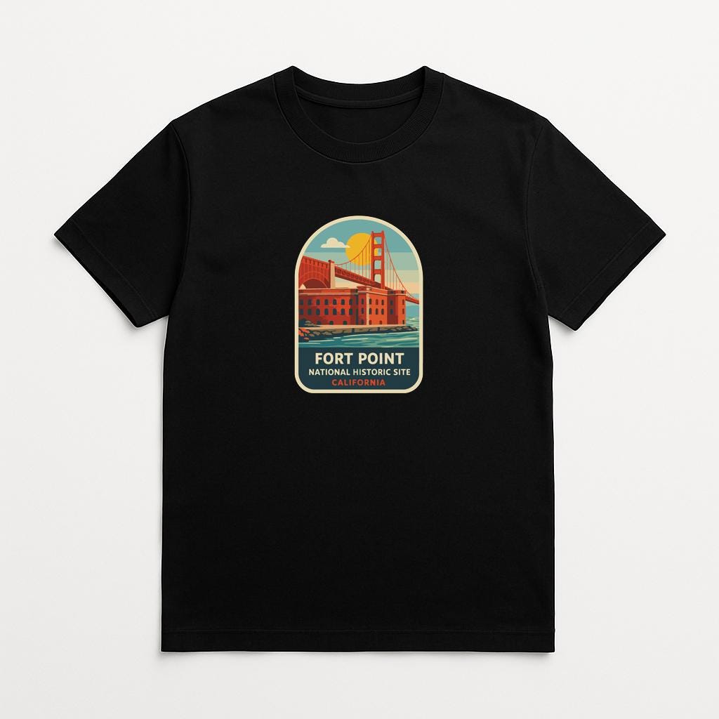A black t-shirt with a graphic design depicting the Golden Gate Bridge and the Fort Point National Historic Site in California.