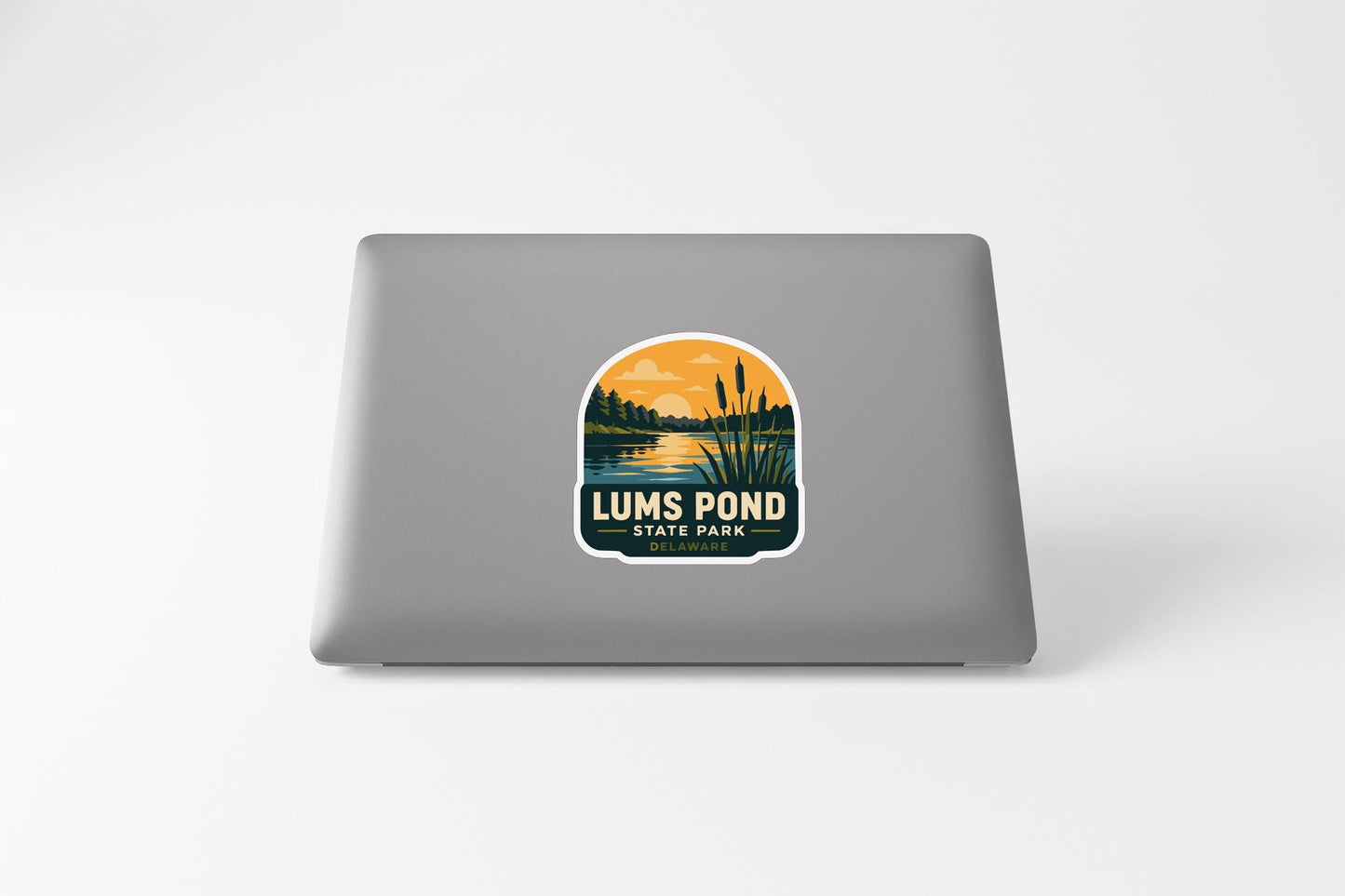 a sticker with a lake and trees on a laptop.
