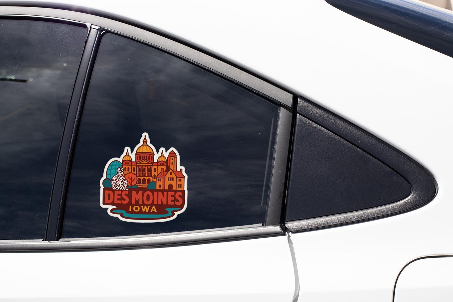 A sticker on the side of a car window that says "DES MOINES IOWA".