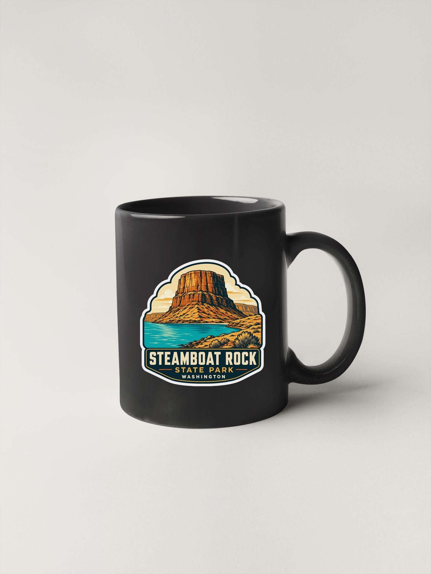 A black coffee mug with a graphic design depicting the Steamboat Rock State Park in Washington State.