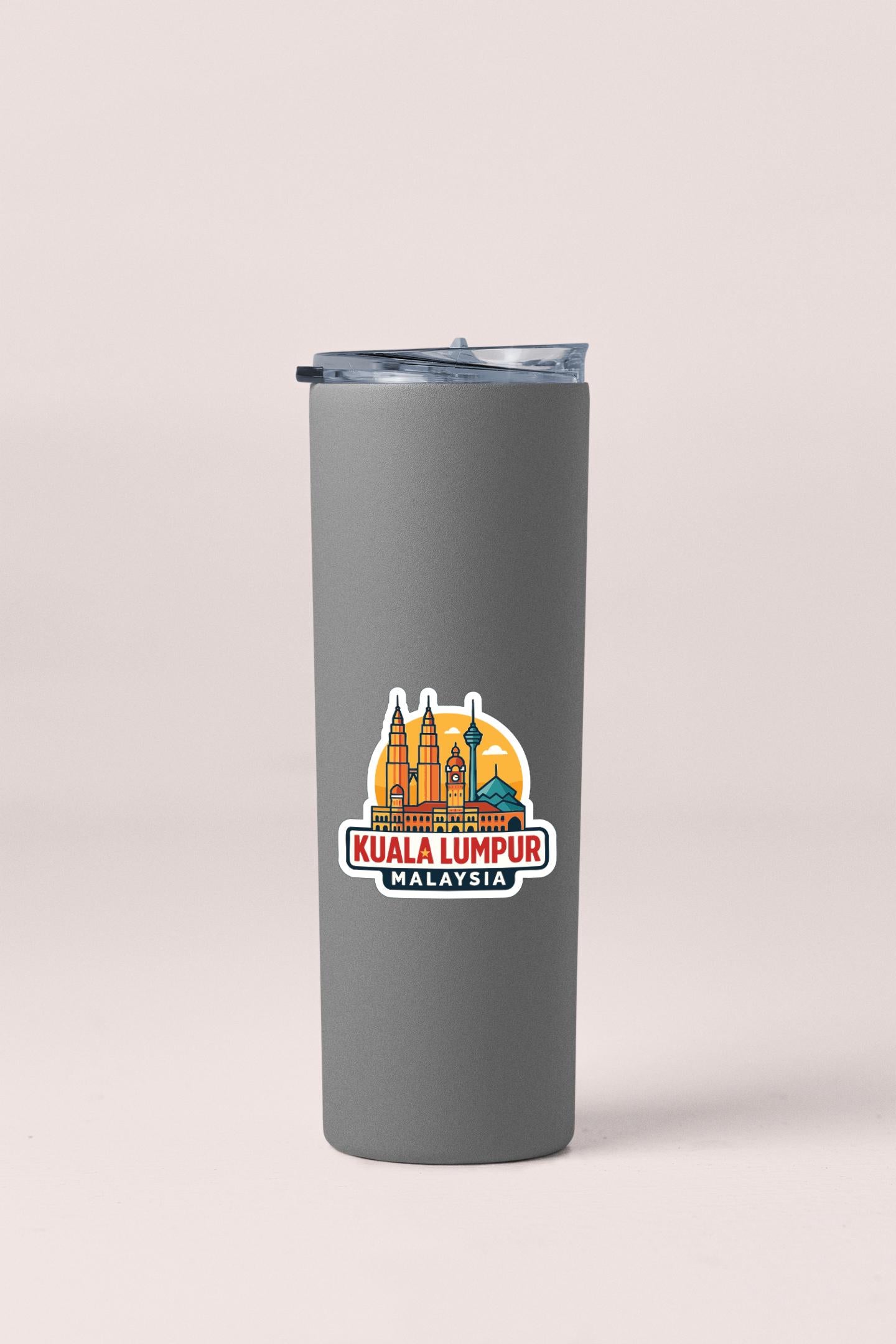 A gray insulated tumbler with a sticker depicting the Kuala Lumpur skyline.