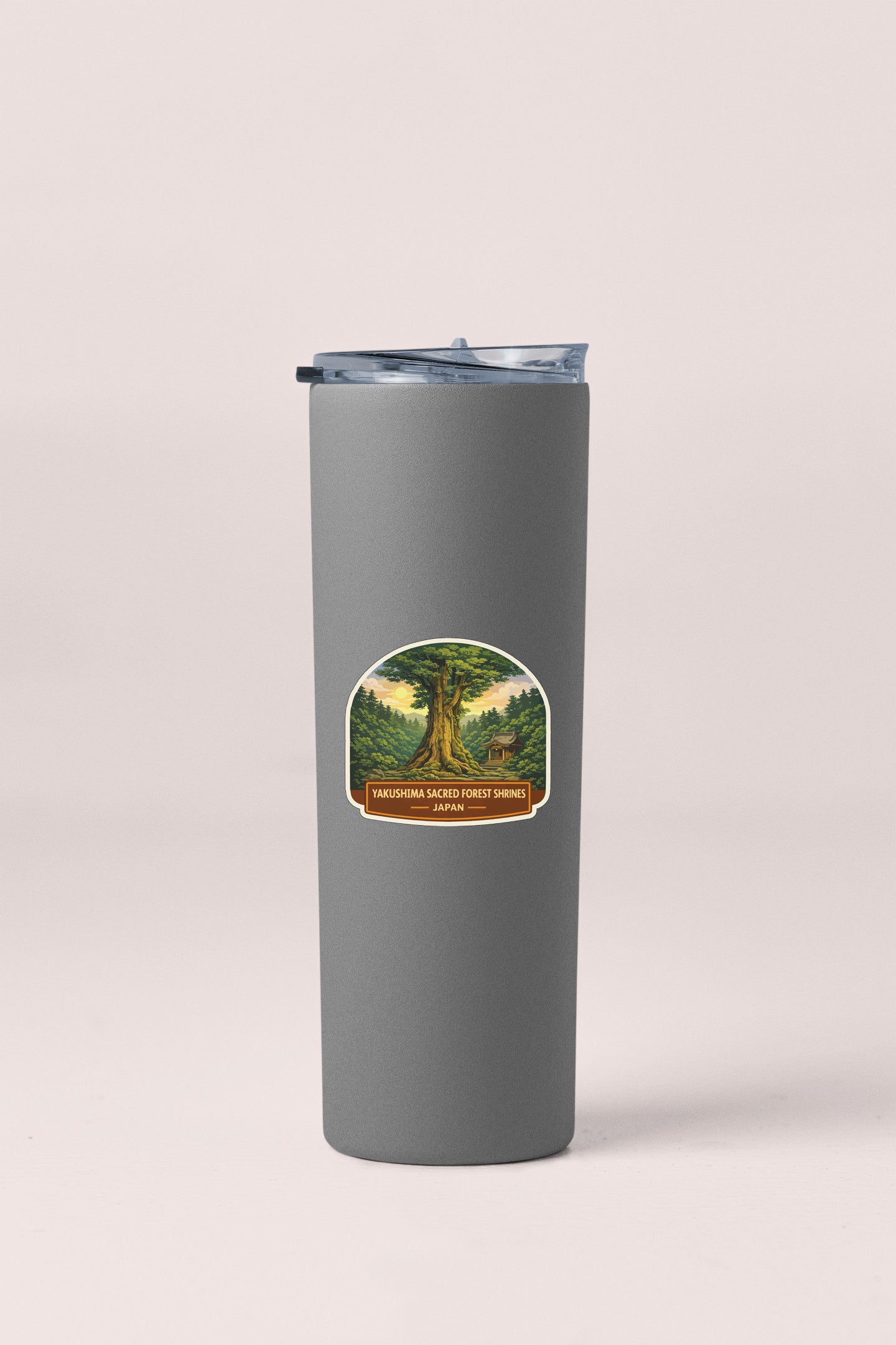 A gray cylindrical container with a lid and a label featuring a tree and forest scene.