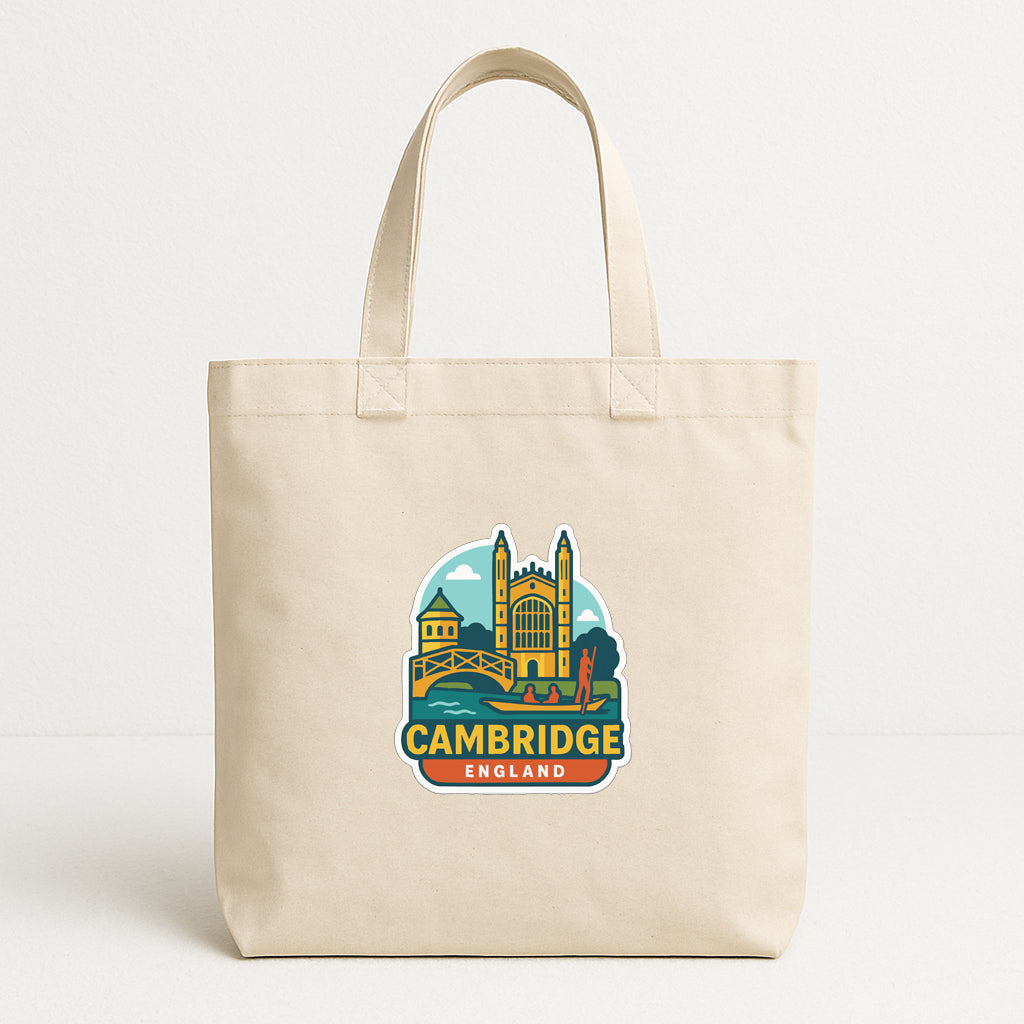 A beige tote bag with a printed design of the city of Cambridge, England, featuring a castle and a river.