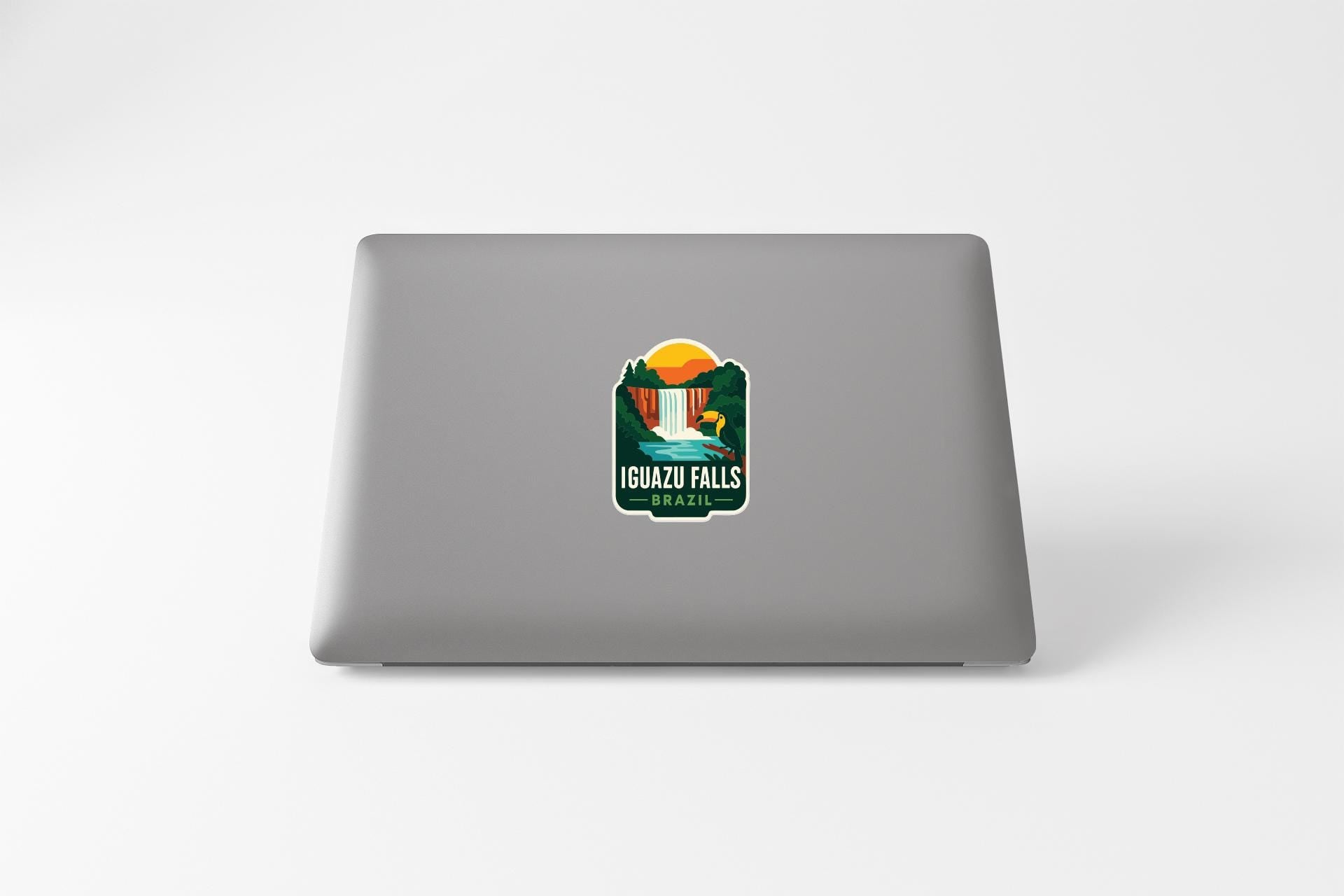 a sticker on the back of a laptop that says "IGUAZU FALLS AIZIL".