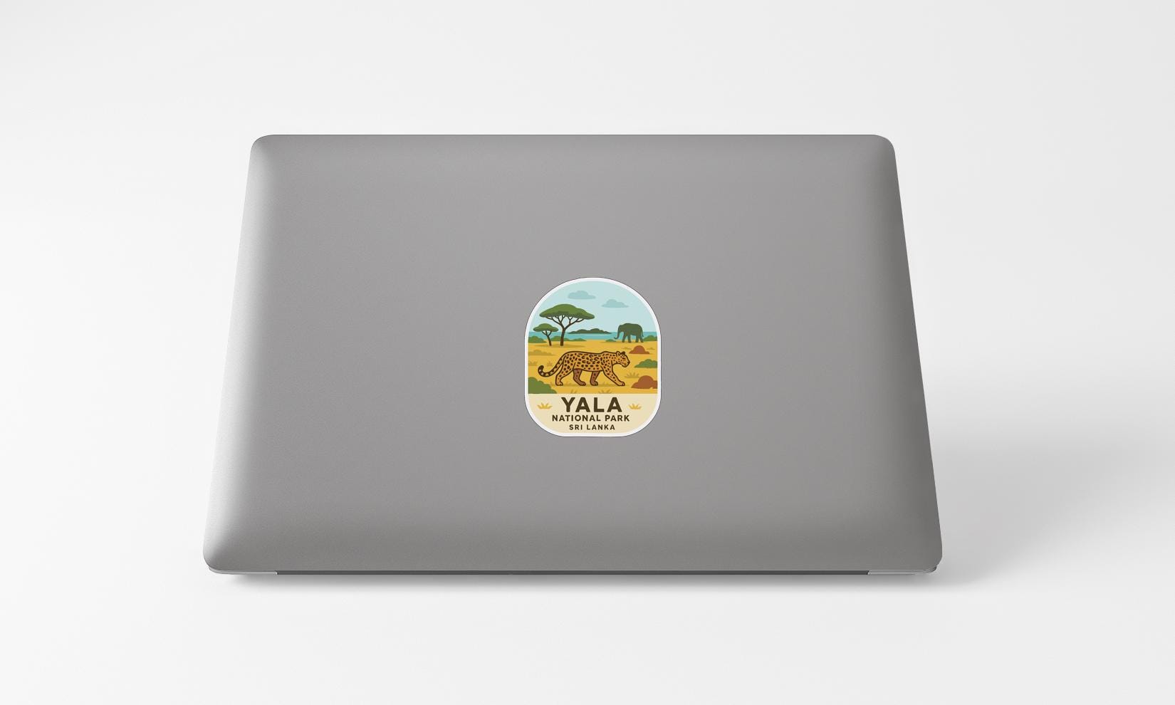 A sticker on the back of a laptop with an illustration of a leopard and the text "YALA NATIONAL PARK" printed on it.