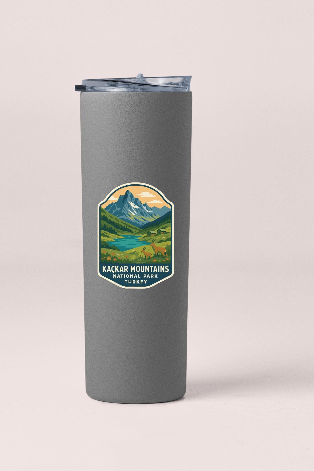 A gray tumbler with a sticker depicting a mountain landscape and the text "Kackar Mountains National Park Turkey".