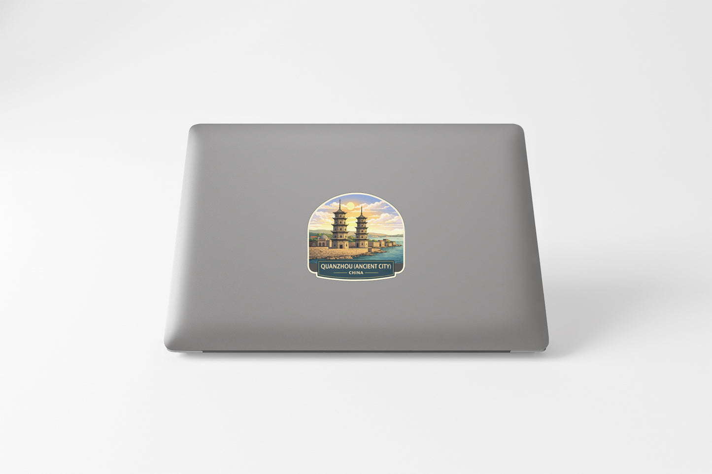 A sticker depicting a pagoda on a laptop.