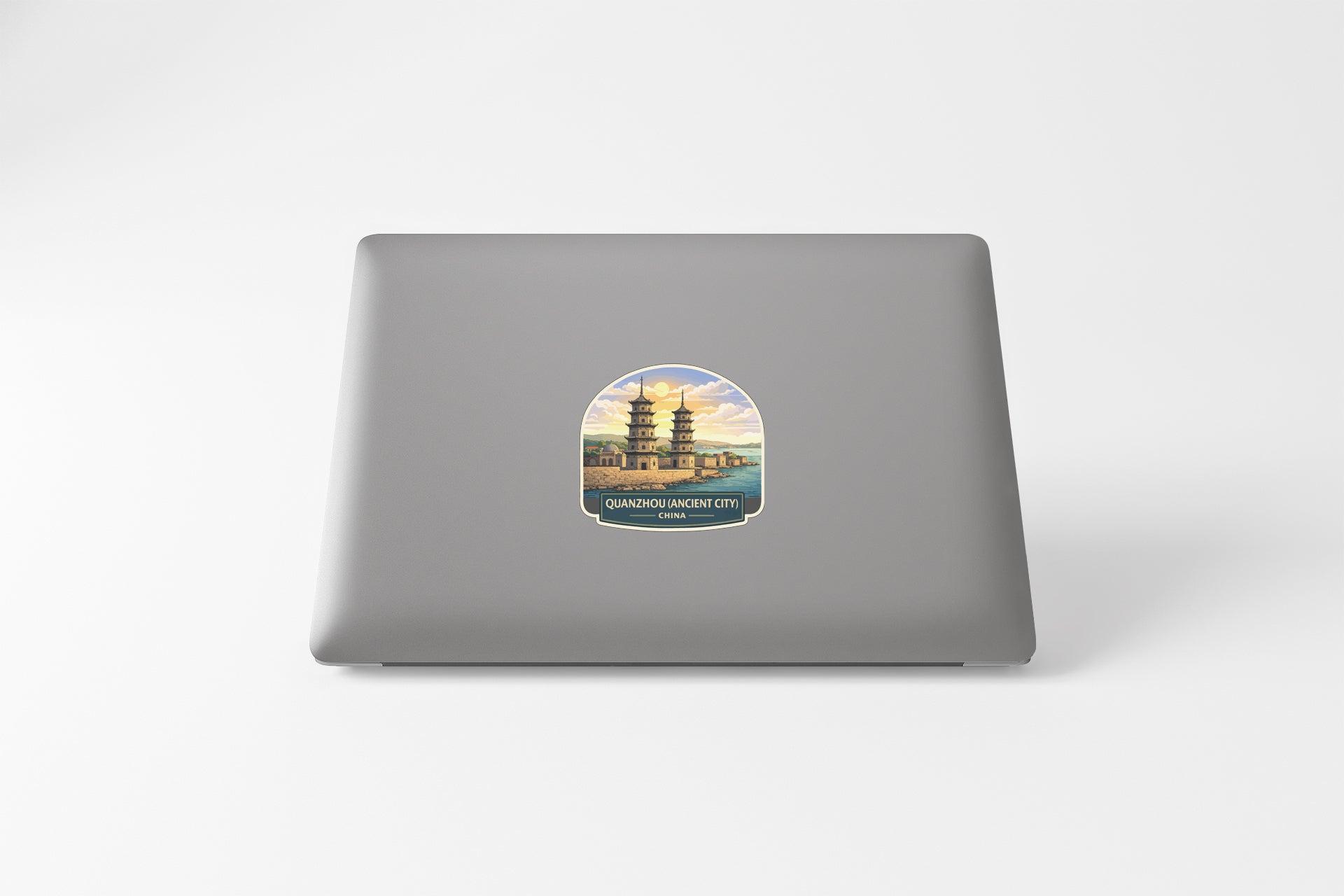 A sticker depicting a pagoda on a laptop.