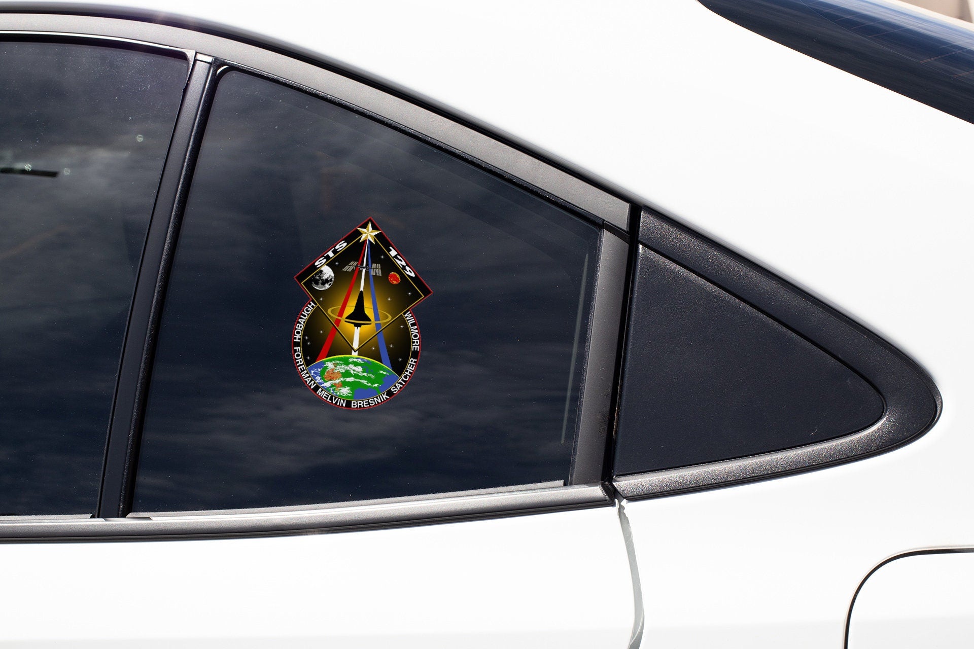 a rear view mirror of a car with a sticker on it