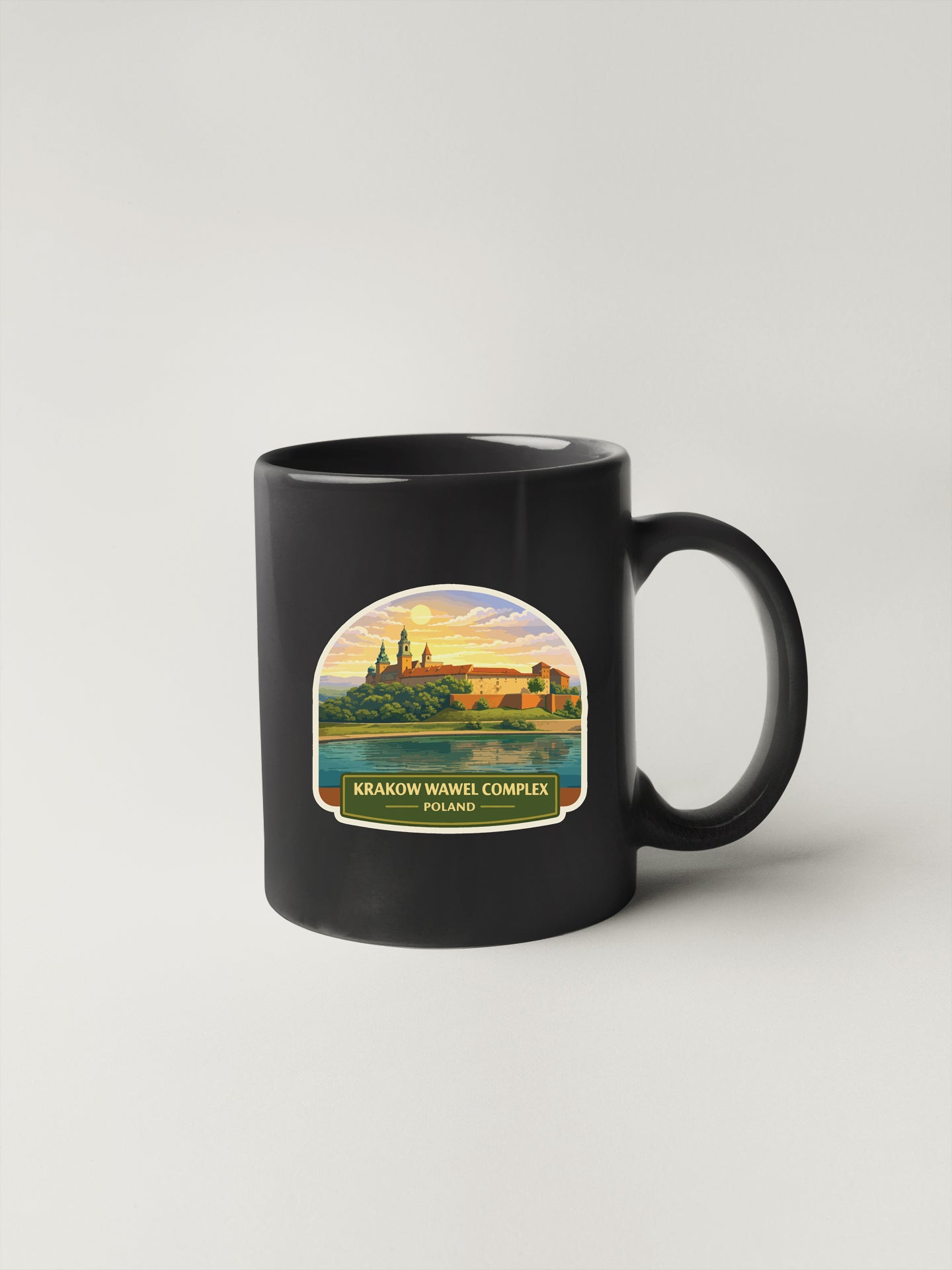 A black coffee mug with a printed image of the Krakow Wawel Complex in Poland.