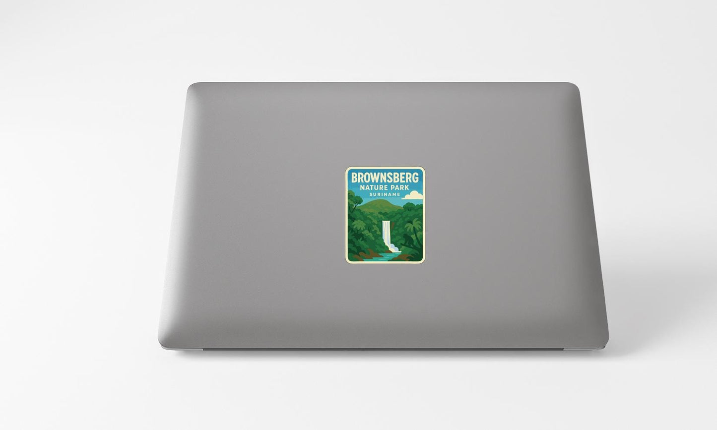 A sticker of a waterfall on the back of a laptop computer.
