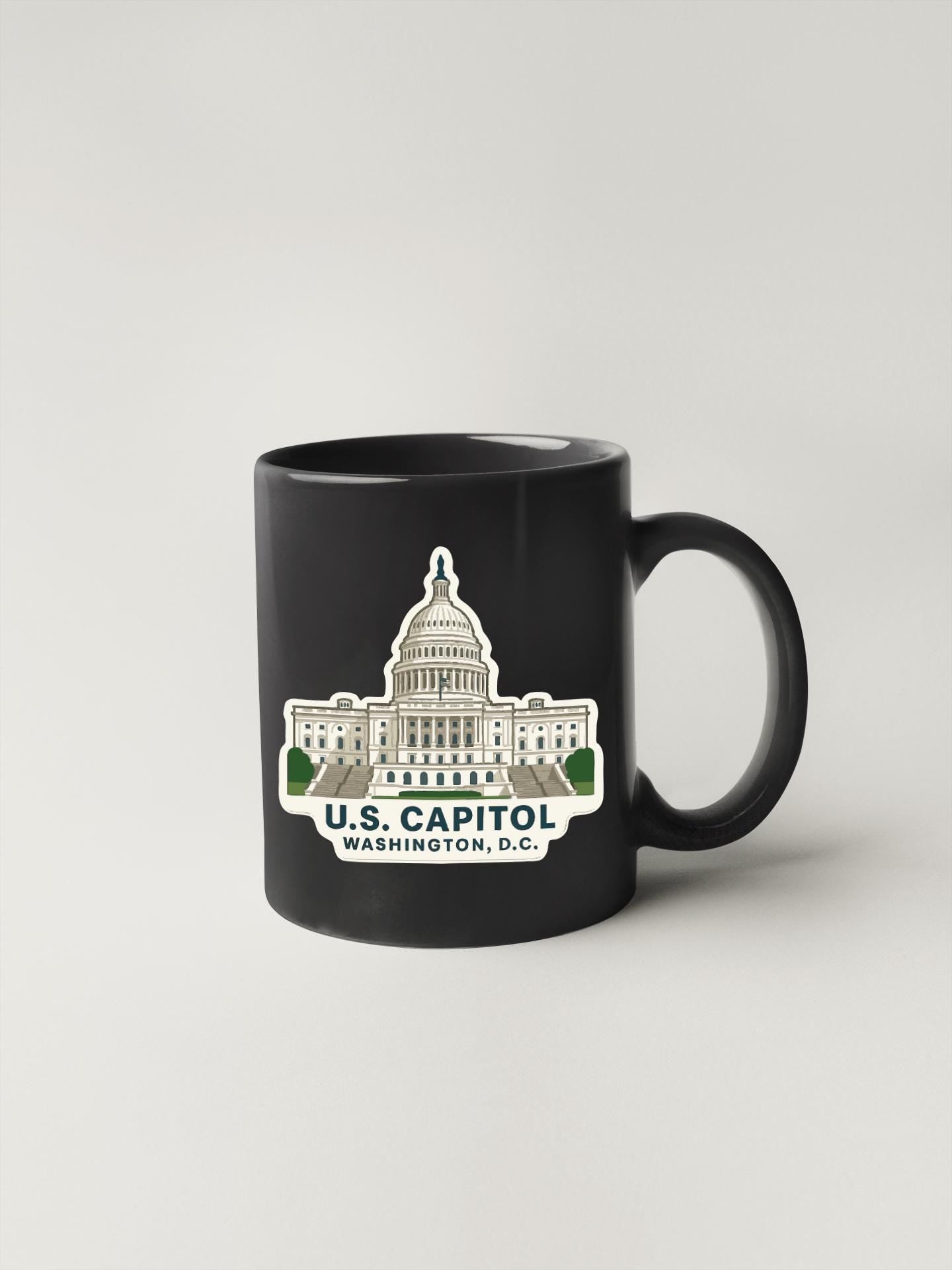 A black coffee mug with a sticker depicting the U.S. Capitol building in Washington, D.C.