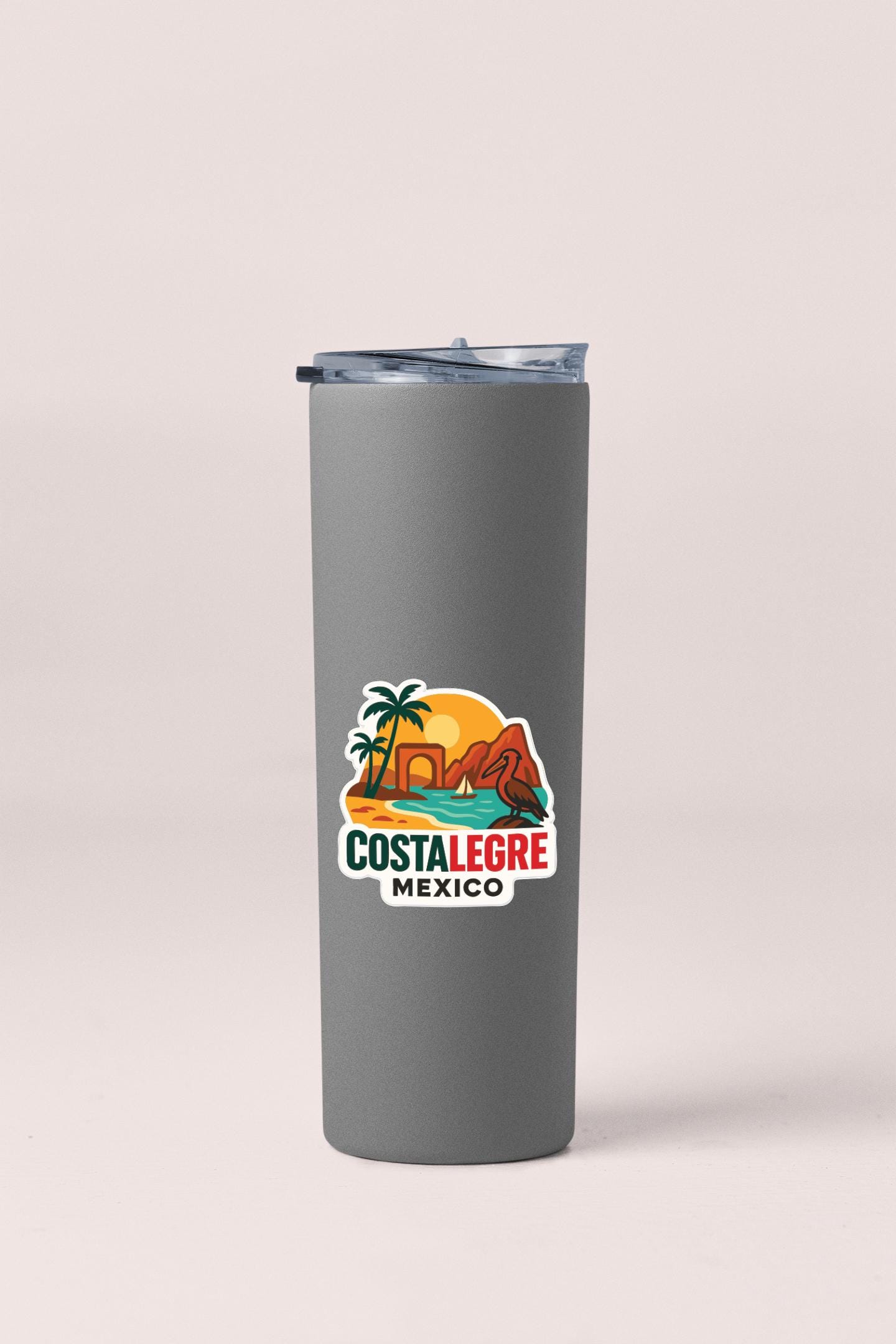 A gray insulated tumbler with a colorful sticker depicting a tropical beach scene and the text "Costañeños de Mexico".