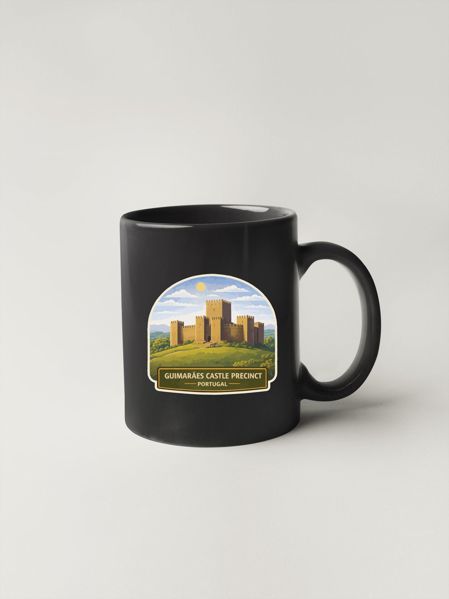 A black coffee mug with a graphic design depicting a castle on a hill.