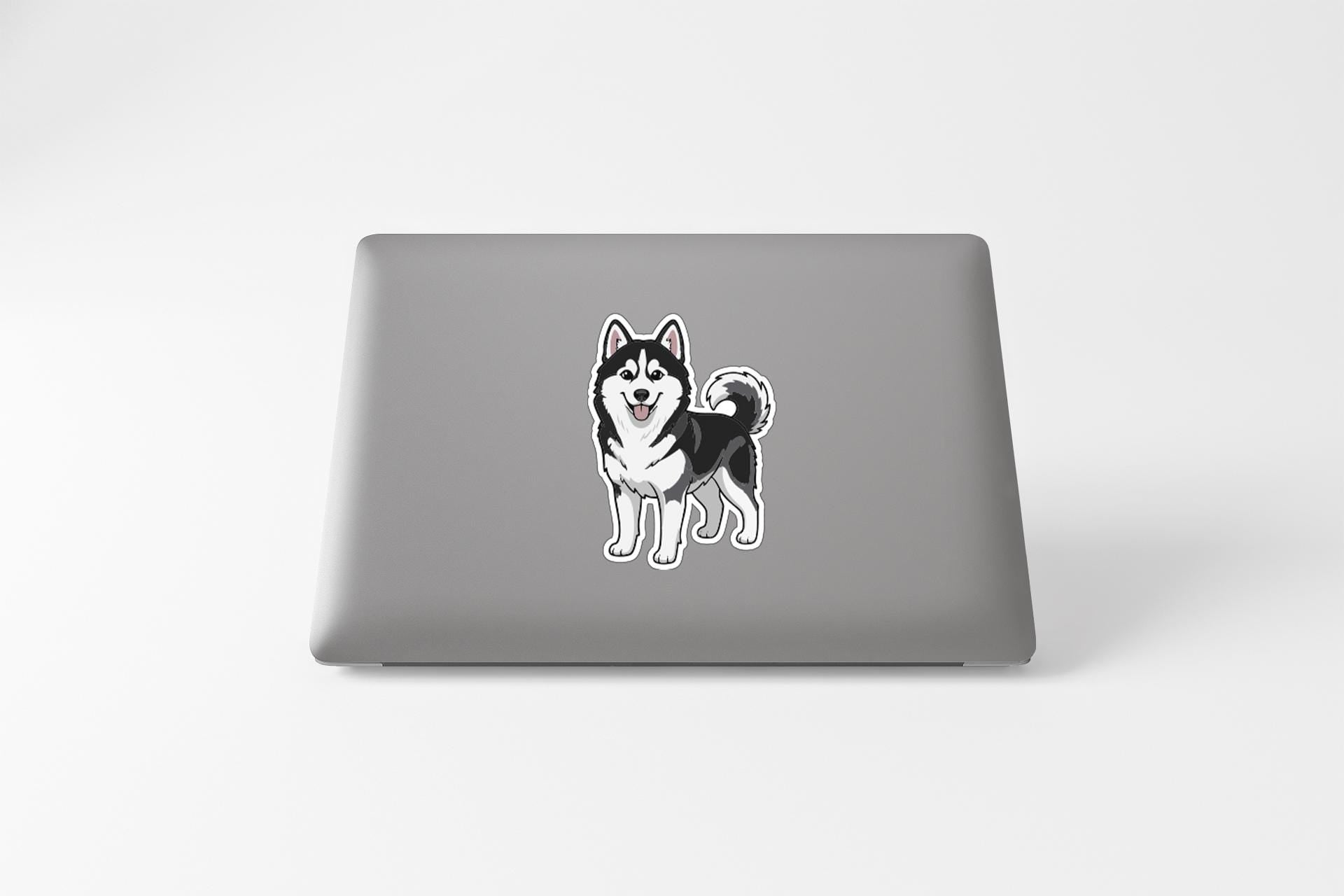A sticker of a husky dog is on the back of a laptop.