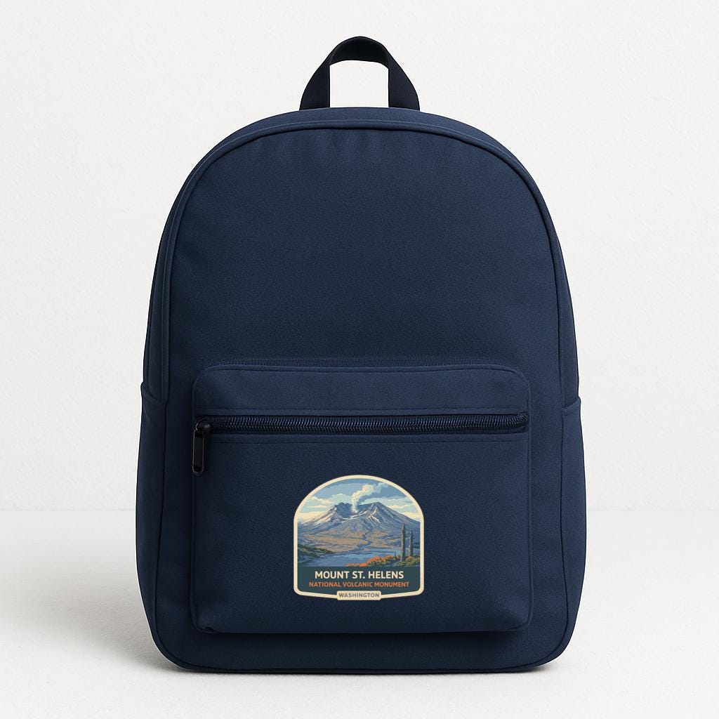A navy blue backpack with a graphic of Mount St. Helens on the front pocket.