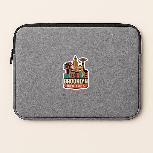 A gray laptop sleeve with a colorful sticker of the Brooklyn skyline on it.