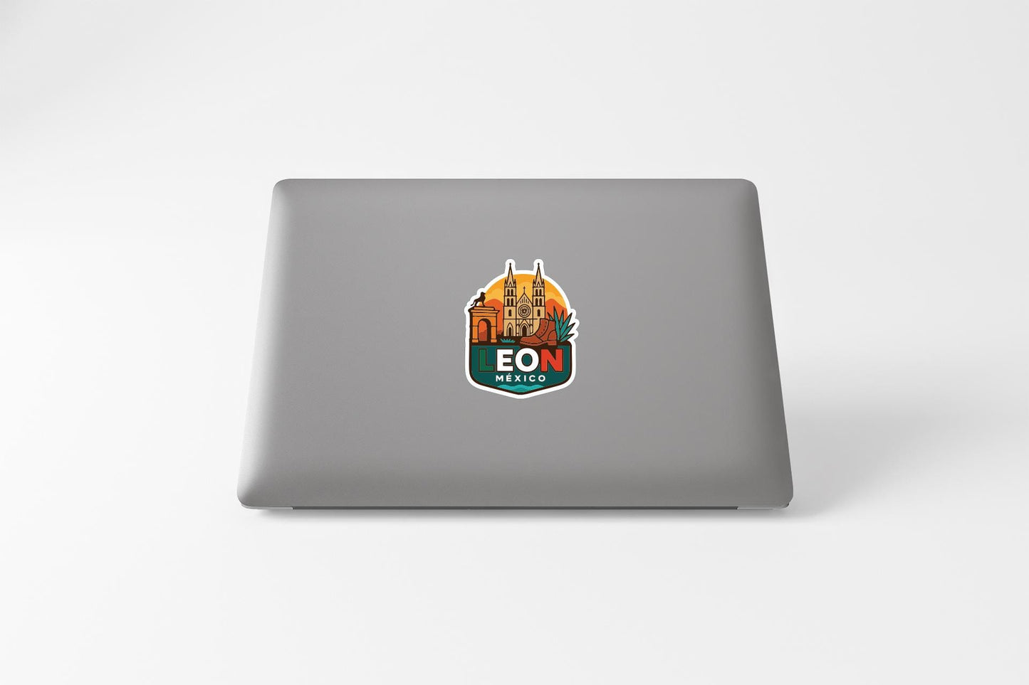 A sticker on the back of a laptop, featuring an illustration of a city skyline with the text "LON" prominently displayed.