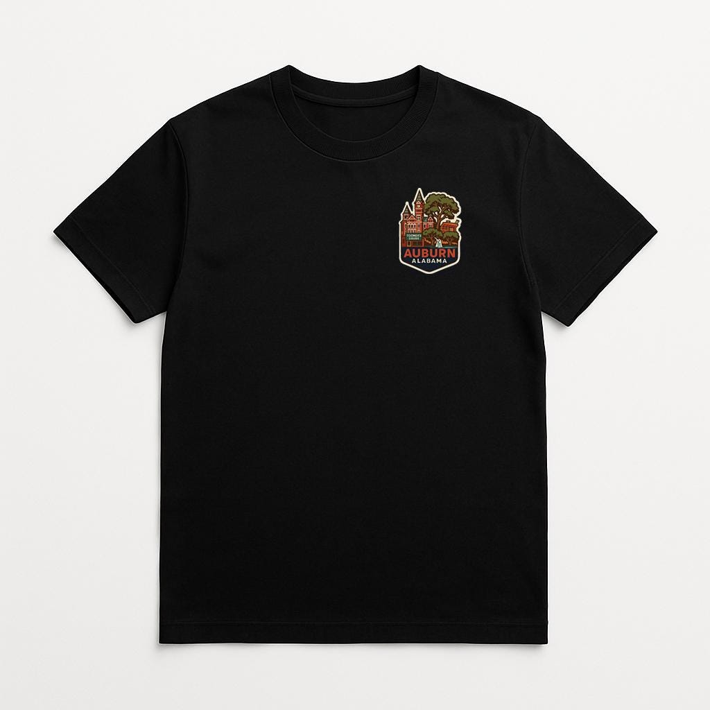 A black t-shirt with a colorful graphic design on the left side.