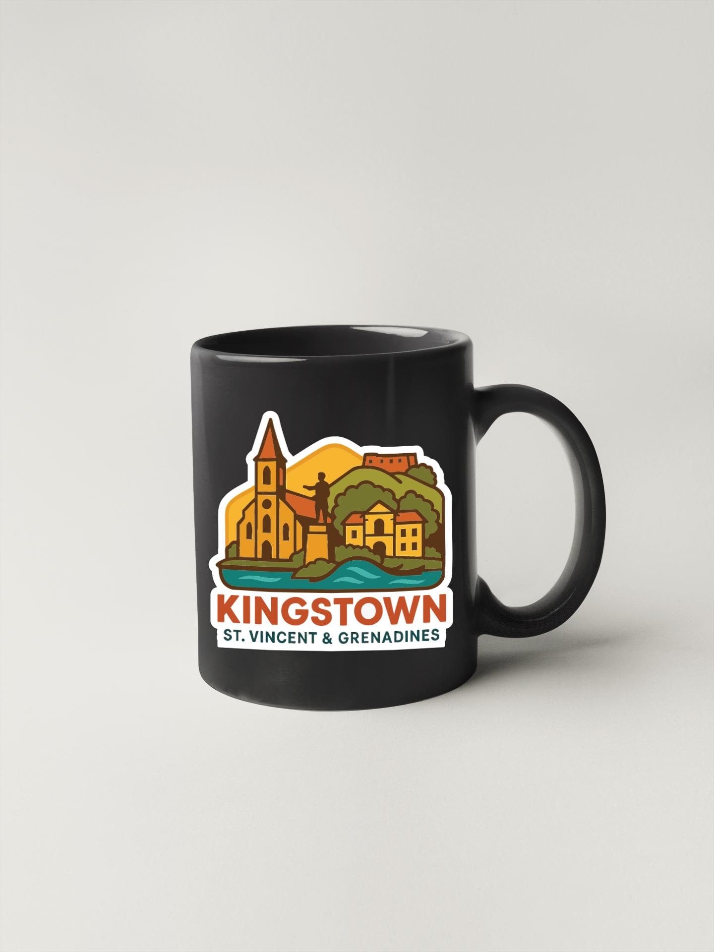 A black coffee mug with a colorful illustration of St. Vincent and Grenadines, featuring a church, buildings, and a landscape.