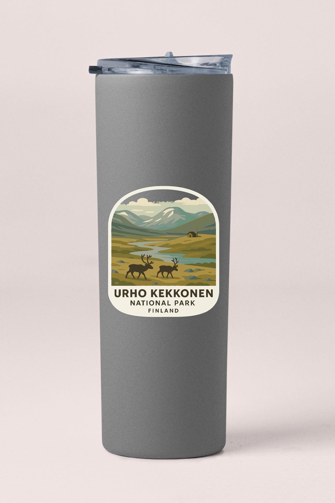A gray cylindrical container with a label that features an illustration of reindeer in a grassy field with mountains in the background.