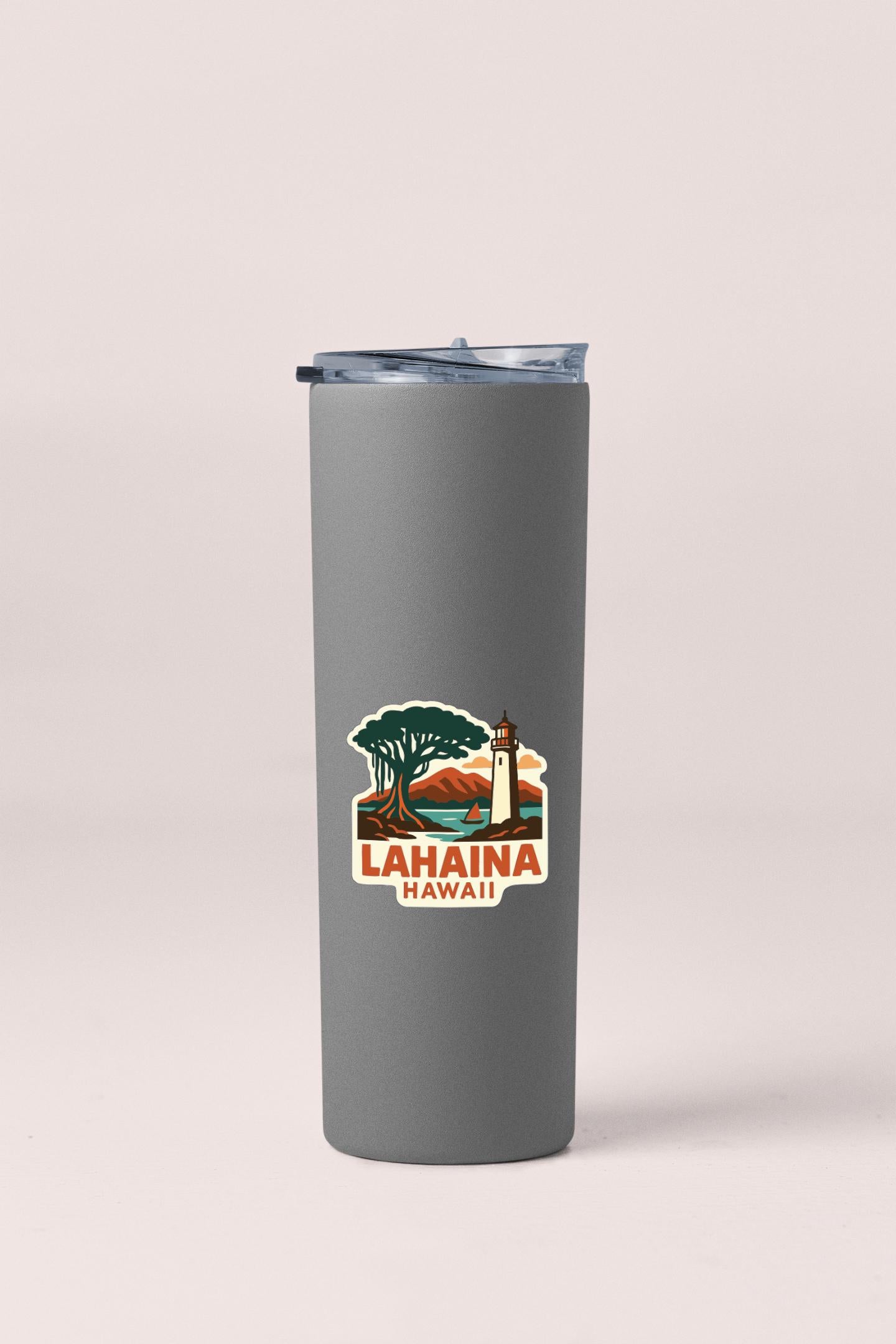 A gray insulated tumbler with a printed sticker depicting a lighthouse and a tree, representing the location of Lhaina, Hawaii.