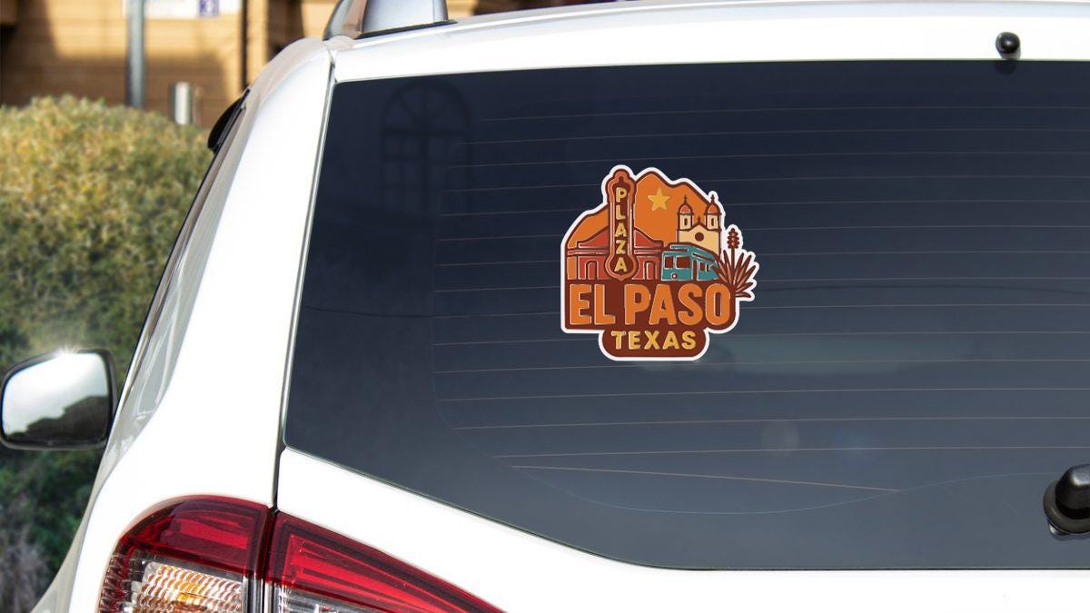 A sticker on the rear window of a white car that says "EL PASO TEXAS".