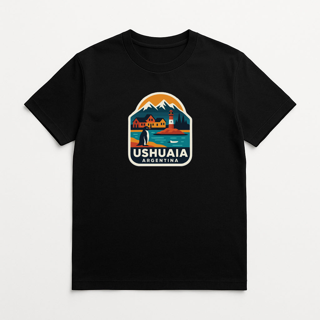 A black t-shirt with a colorful graphic design depicting a scenic landscape with mountains, a lighthouse, and a small boat on a lake.