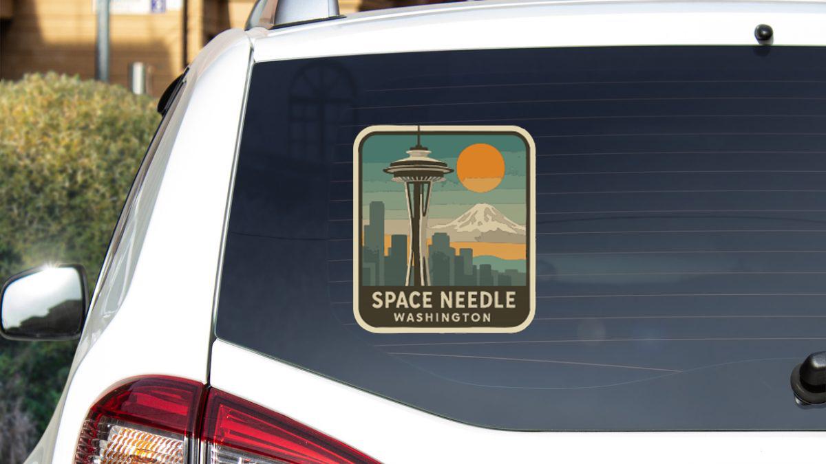 a sticker on the rear window of a car that says "Space Needle Washington".