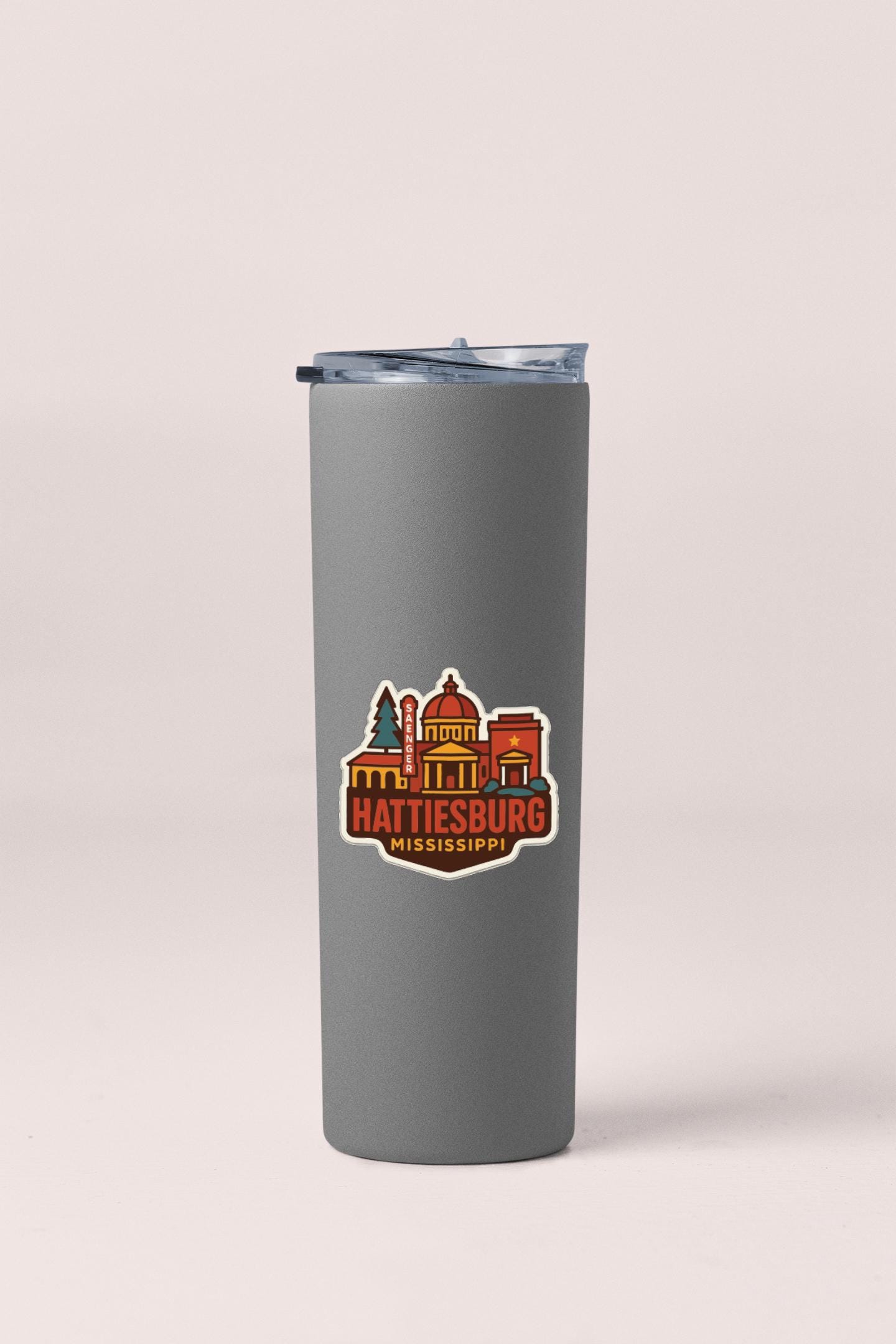 A gray insulated tumbler with a sticker depicting the Hattiesburg, Mississippi city.