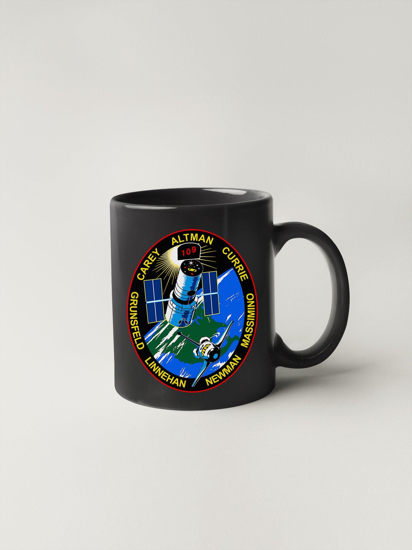 a black mug with a nasa emblem on it