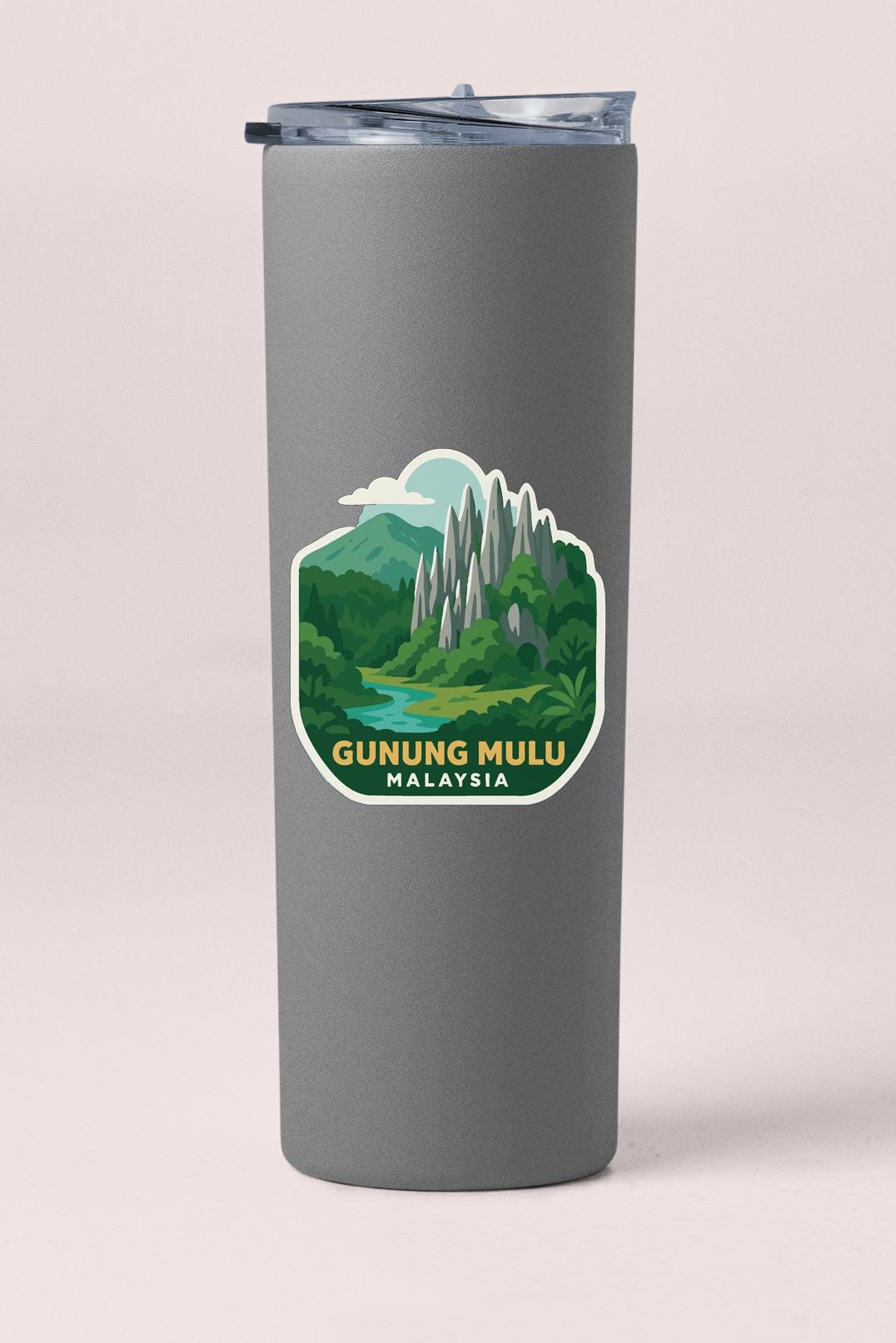 A gray cylindrical container with a sticker depicting a scenic landscape of mountains, trees, and a river.