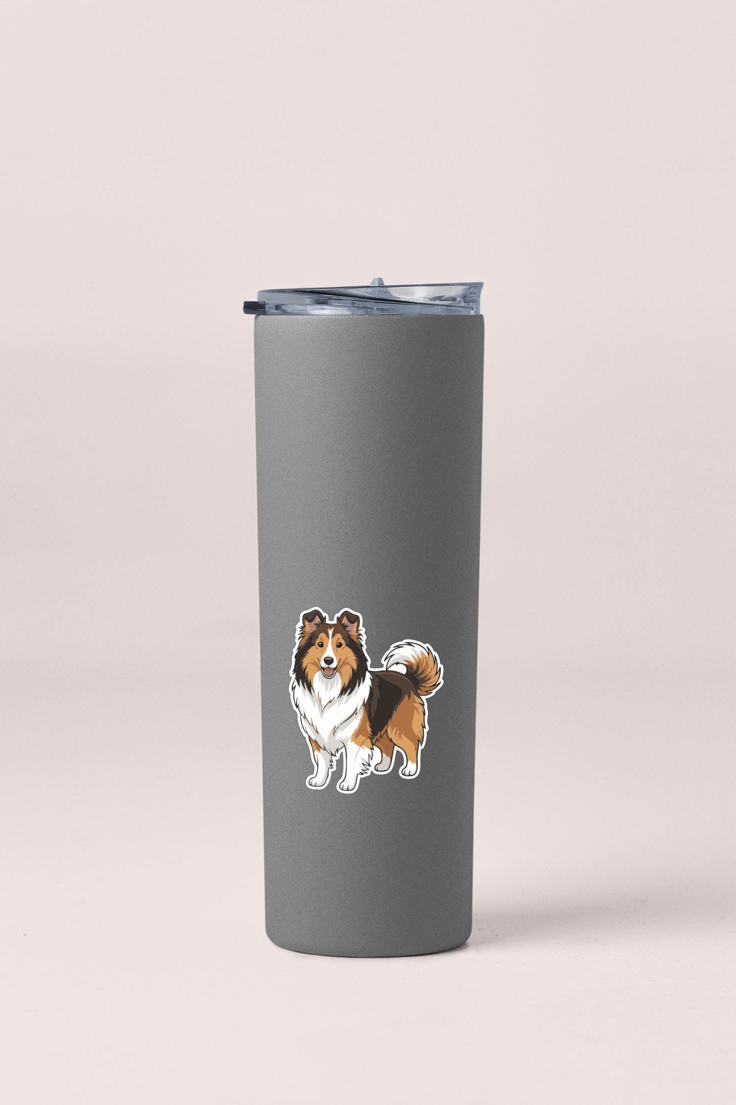 A gray insulated tumbler with a cartoon illustration of a dog on the front.