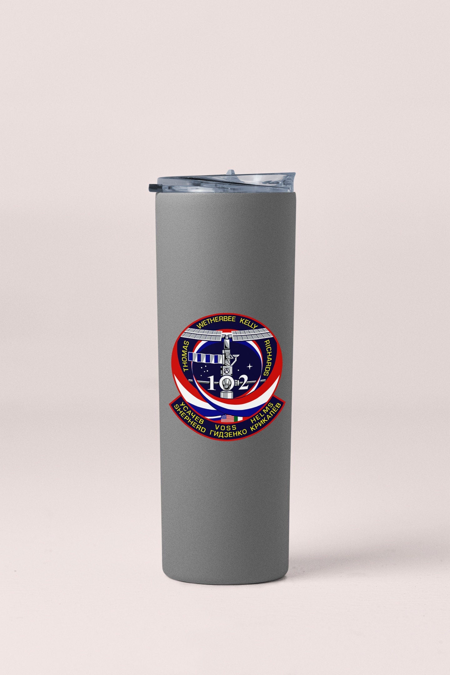 a gray tumbler cup with a red, white, and blue design on it