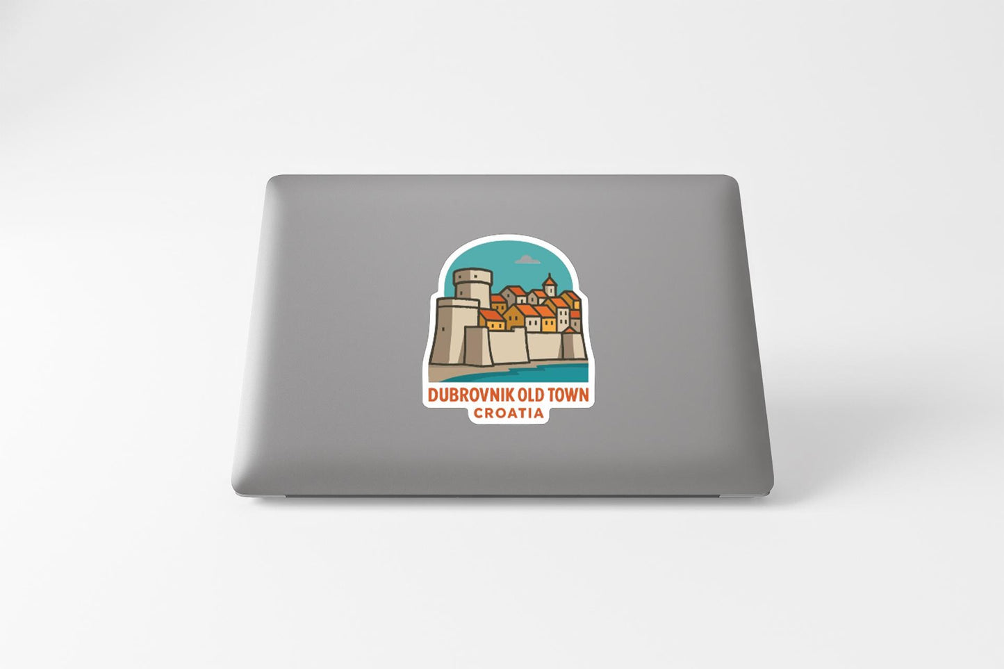a sticker depicting a cityscape with a castle, and the text "DUBROVnik Old Town Croatia" is printed on it.