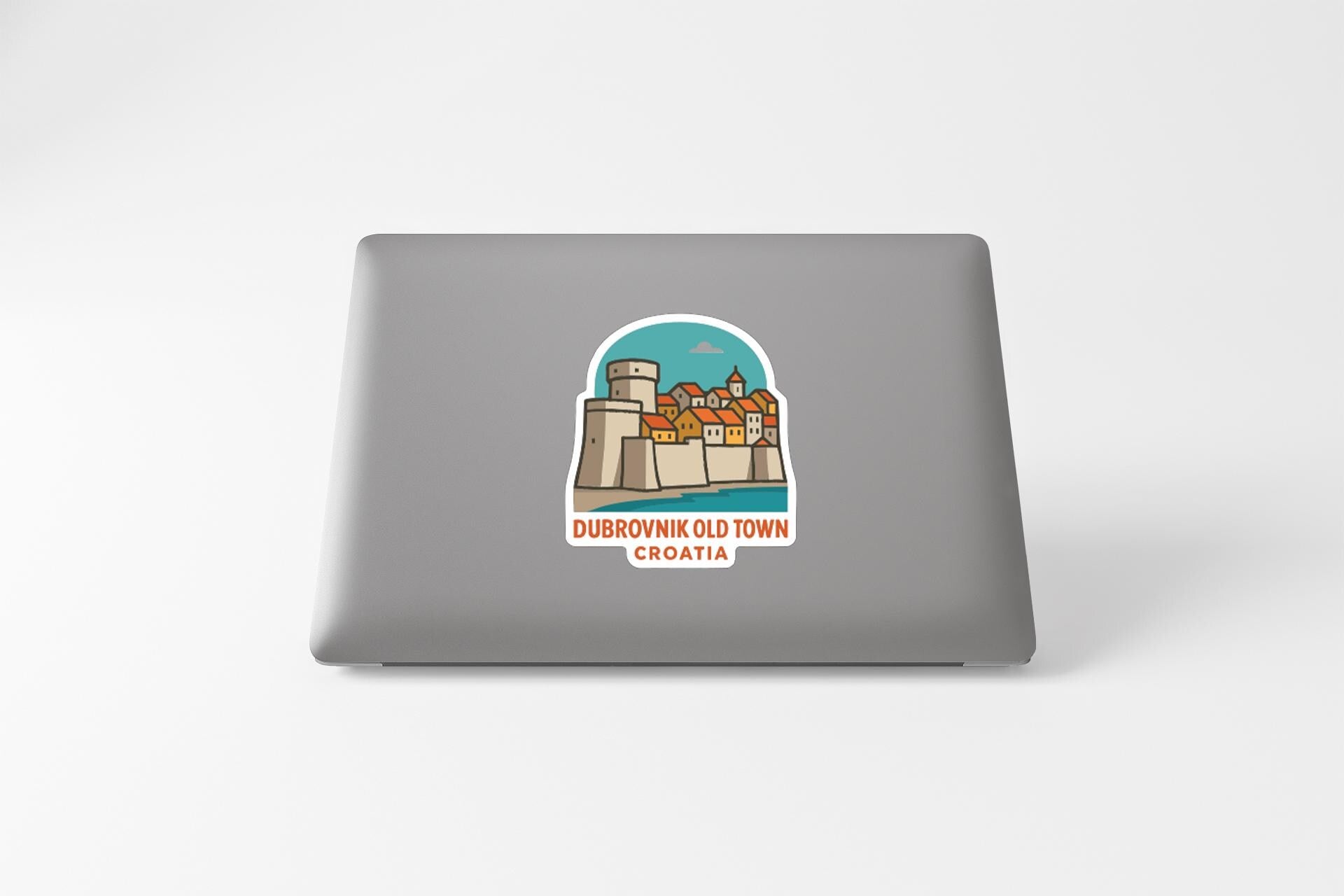 a sticker depicting a cityscape with a castle, and the text "DUBROVnik Old Town Croatia" is printed on it.