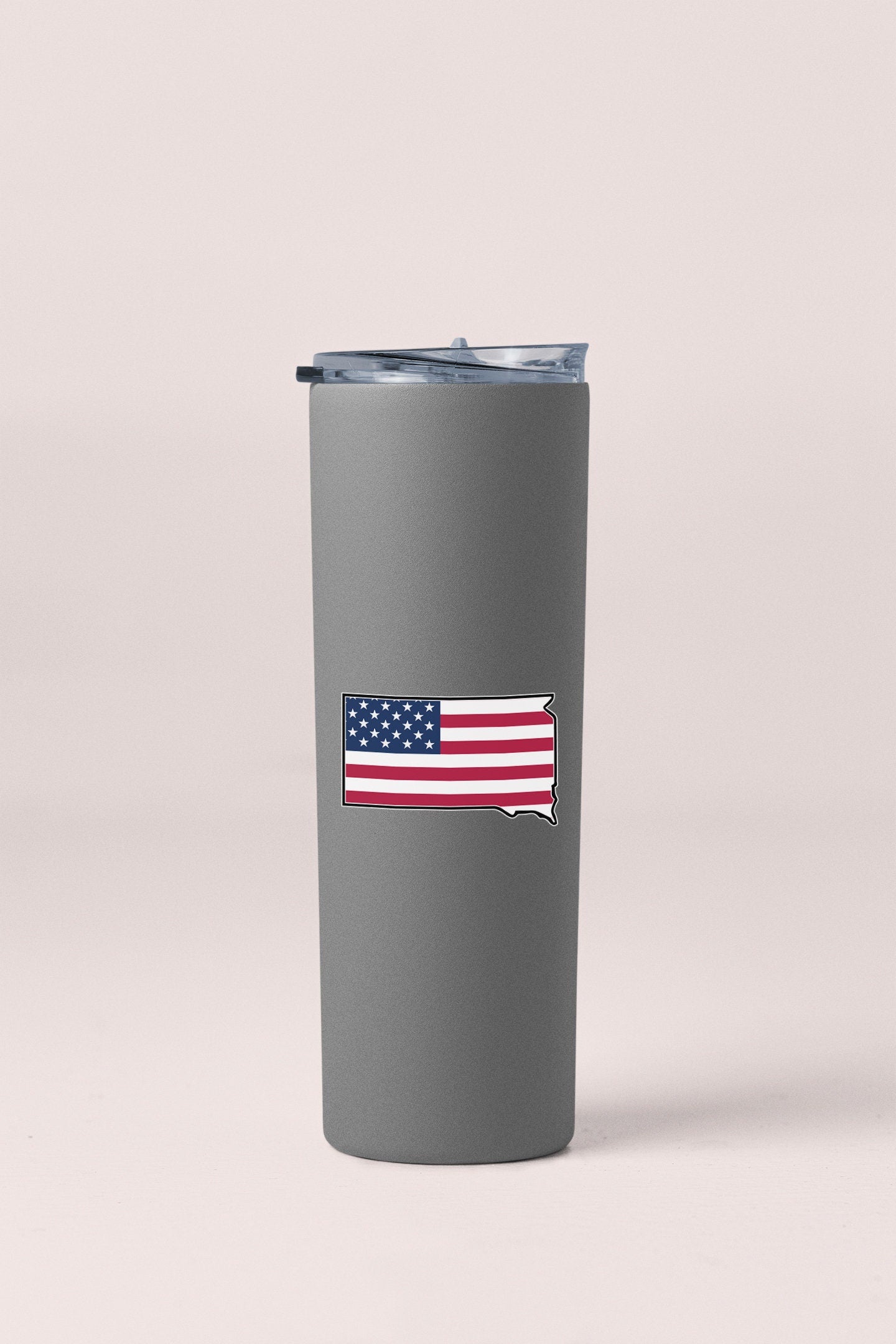 a gray tumbler with a flag on the side