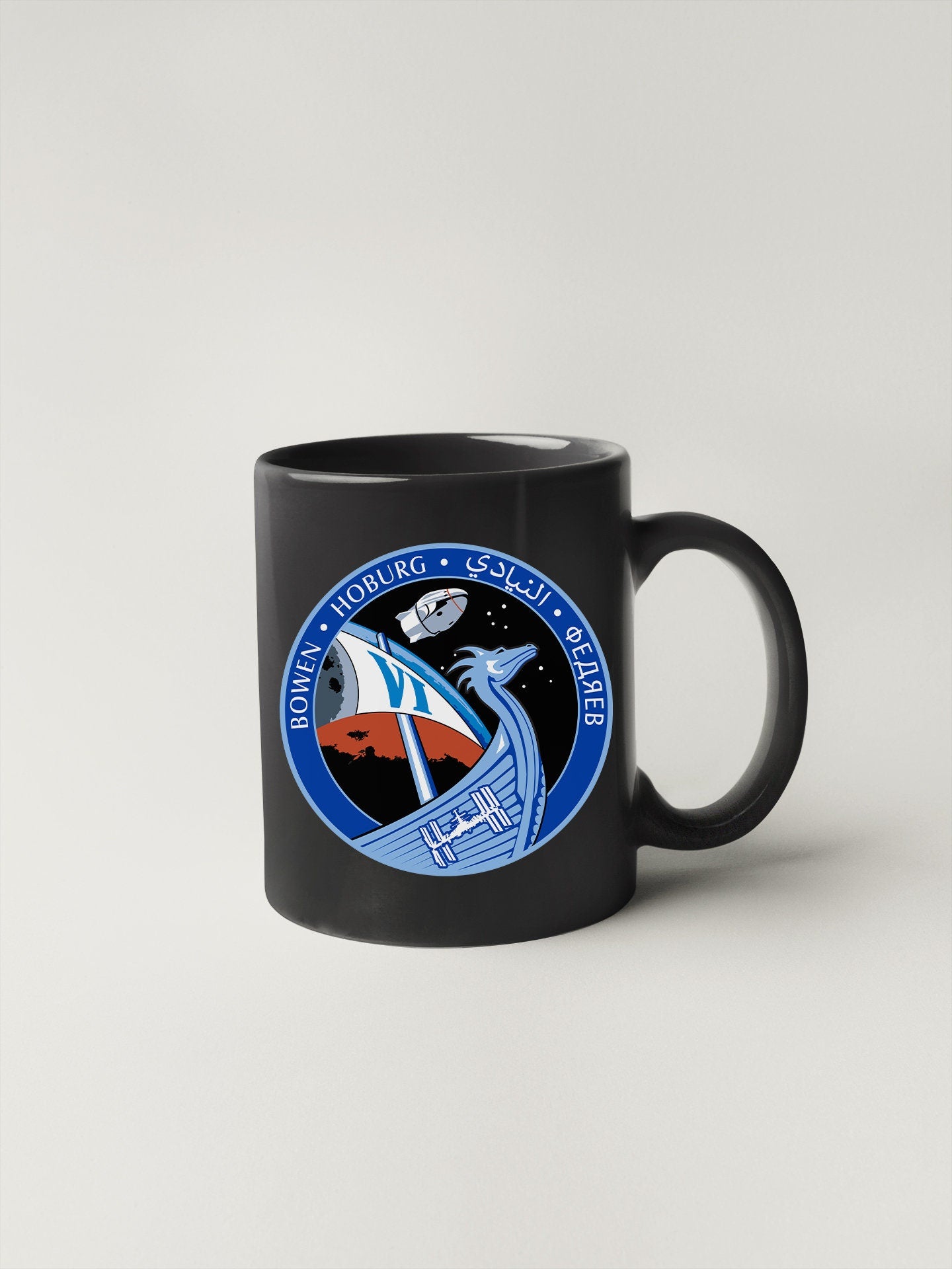 a black mug with a nasa emblem on it