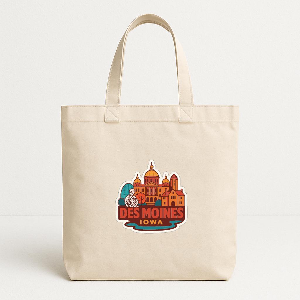 A beige tote bag with a colorful graphic of the skyline of Des Moines, Iowa, printed on it.