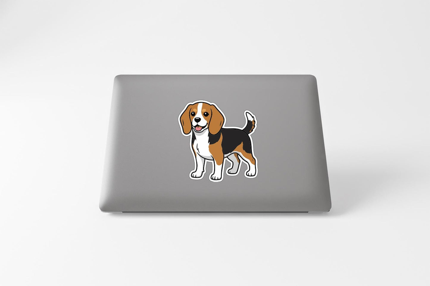 A sticker of a cartoon beagle dog on the back of a laptop computer.