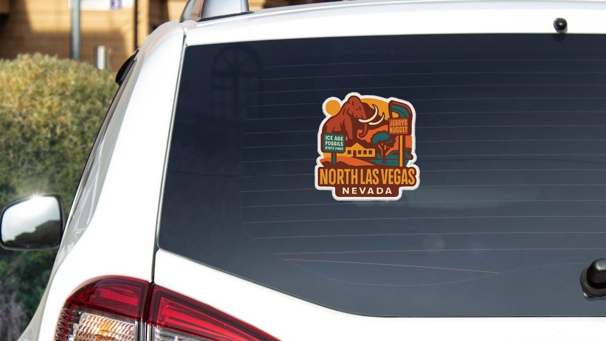 A sticker on the rear window of a vehicle, depicting a cartoon elephant and the text "NORTH LAS VEGAS NEVADA".