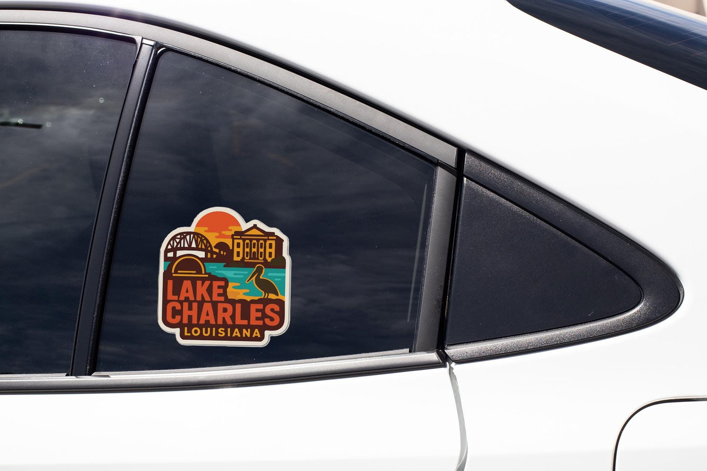 A sticker on the side of a car window, featuring a scenic image of Lake Charles, Louisiana.